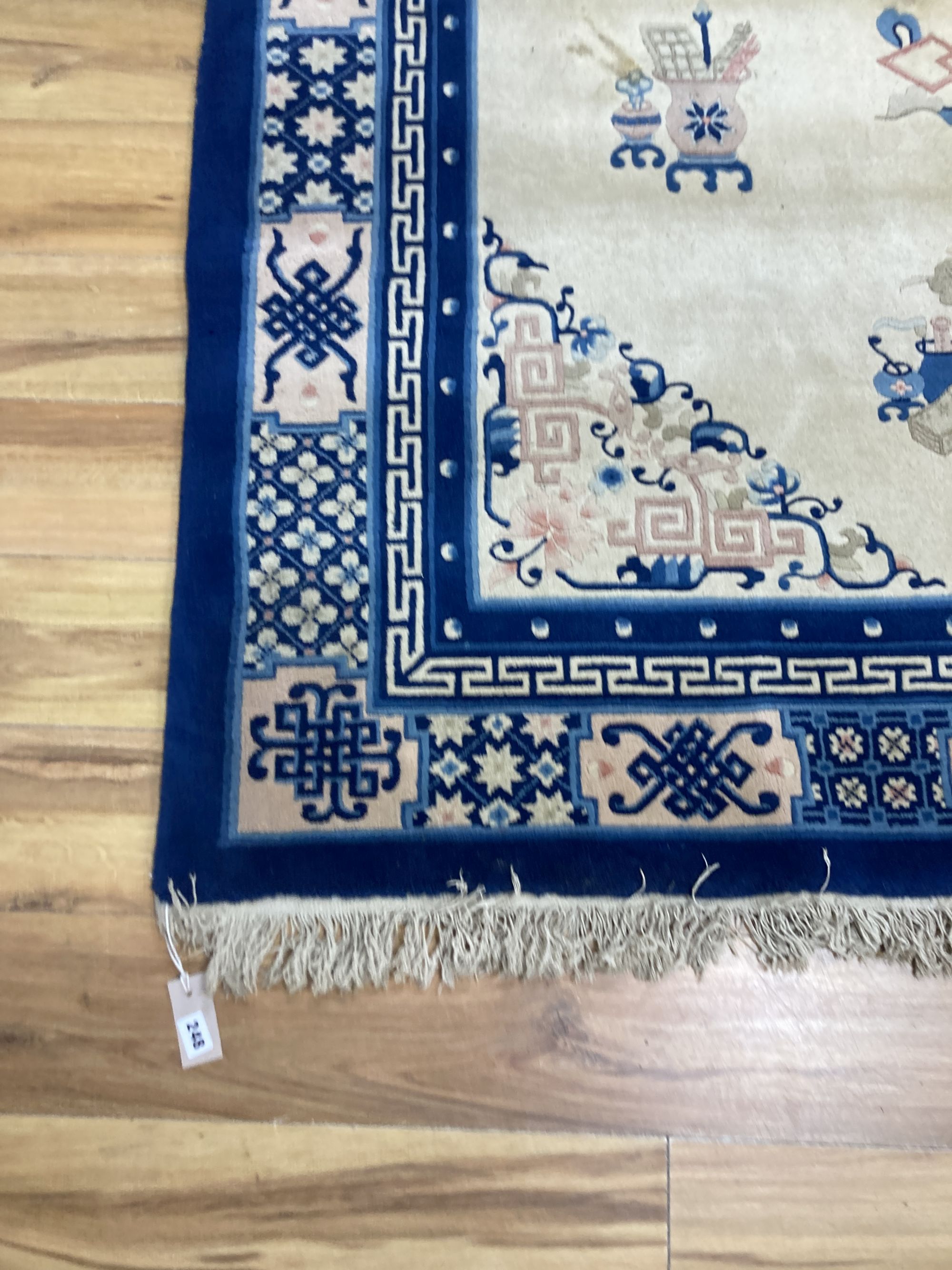A Chinese wool cream ground rug,